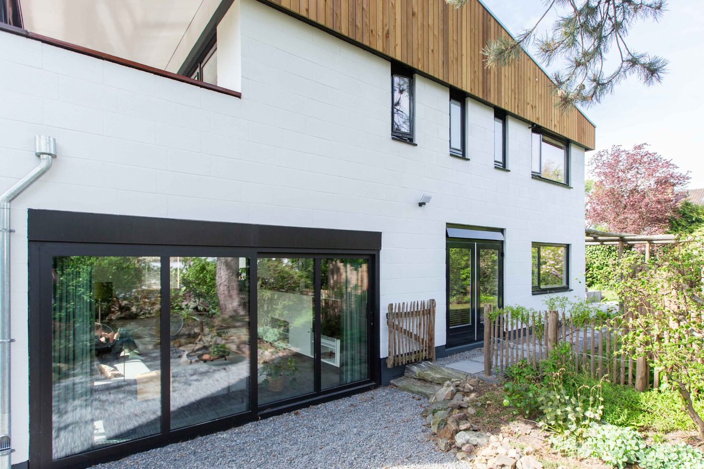 Moderne woning met wit geschilderd metselwerk en zwarte kozijnen